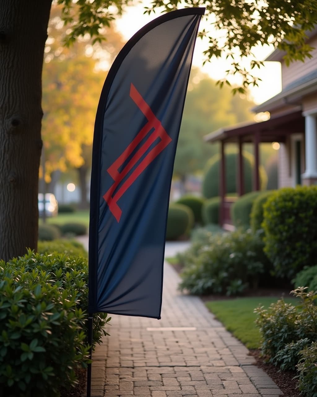 A navy Meridian Realty feather flag at an open-house walkway
